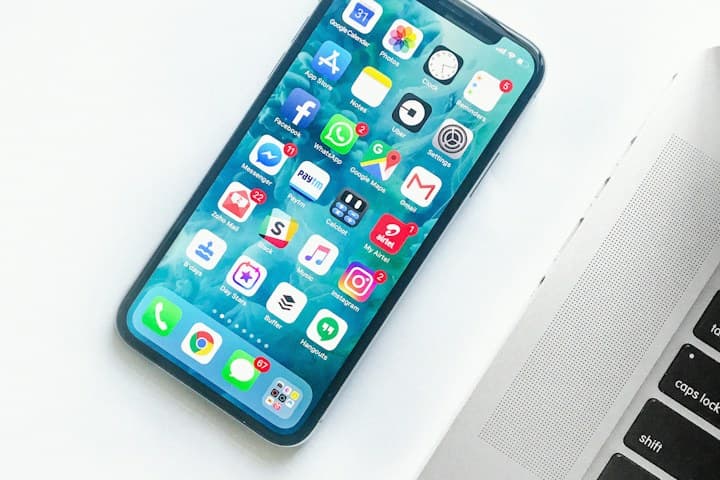 Smartphone home screen with app icons on a white desk